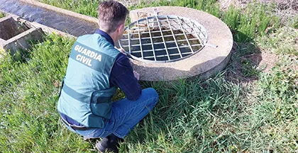Un agente del Equipo Roca de la Guardia Civil ante una de las rejillas de seguridad.. -